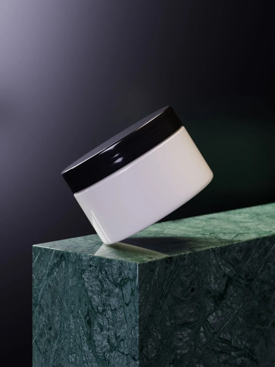 An unlabelled white cosmetic jar with a black lid, set at an angle on a green marble block.